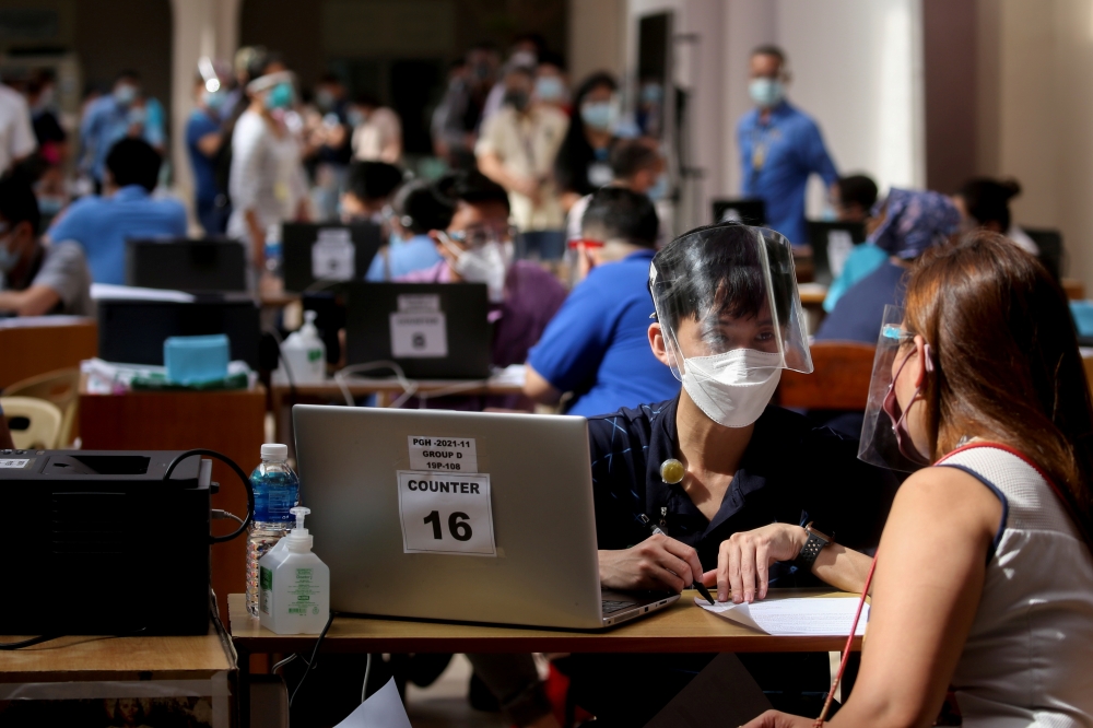Health workers and employees of Philippine General Hospital register for COVID-19 vaccination, expected to arrive this month, at the Philippine General Hospital in Manila, Philippines, February 9, 2021. REUTERS/Eloisa Lopez/File Photo