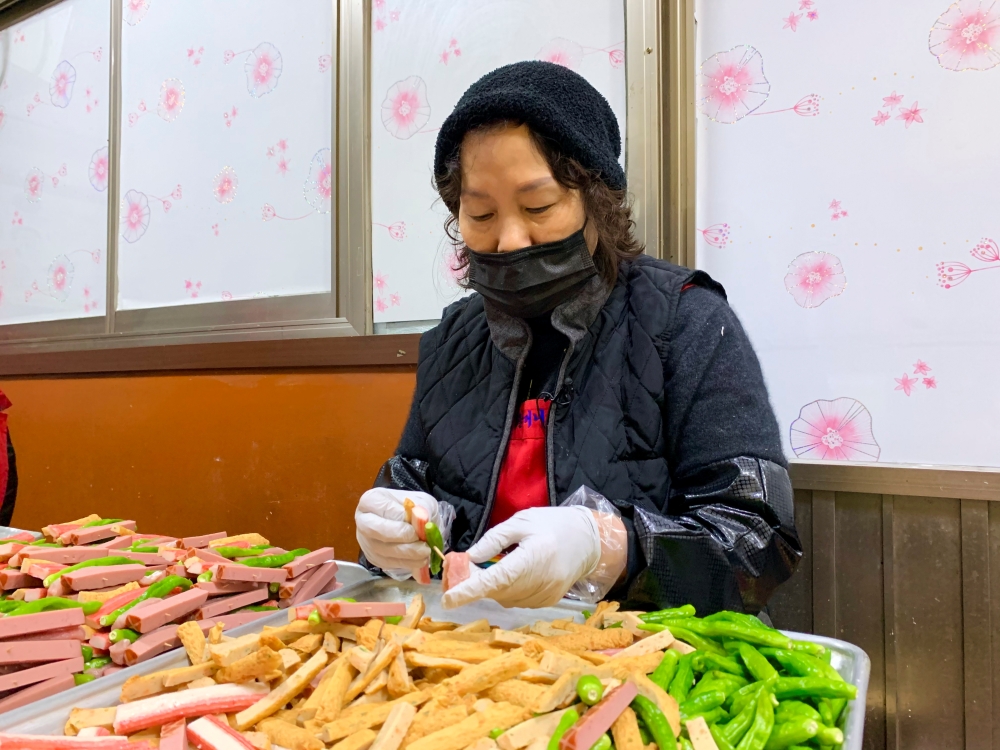 Lee Soon-ai, owner of a Korean traditional pancake house for over 15 years, puts meat onto skewers to sell for the Lunar New Year, in Seoul, South Korea February 11, 2021. REUTERS/Minwoo Park
