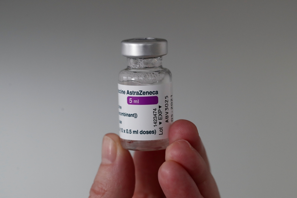 A member of the medical staff holds a vial of the Oxford-AstraZeneca COVID-19 vaccine at the Foch hospital in Suresnes, near Paris, France, February 8, 2021. REUTERS/Benoit Tessier/File Photo