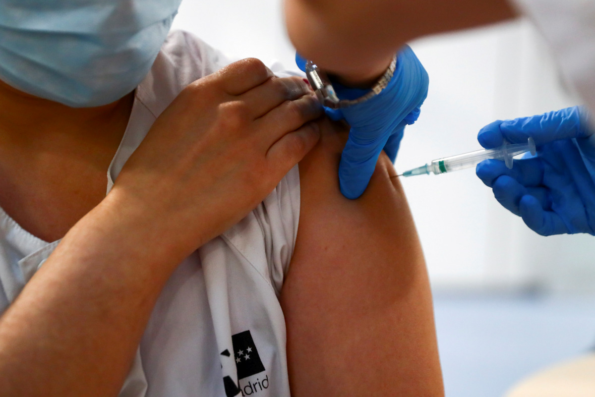 FILE PHOTO: A health worker receives an injection with her second dose of the Pfizer-BioNTech COVID-19 vaccine, as the coronavirus disease (COVID-19) outbreak continues, at Enfermera Isabel Zendal new pandemic hospital in Madrid, Spain, February 4, 2021. 