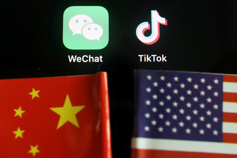 FILE PHOTO: The messenger app WeChat and short-video app TikTok are seen near China and U.S. flags in this illustration picture taken August 7, 2020. REUTERS/Florence Lo/Illustration

