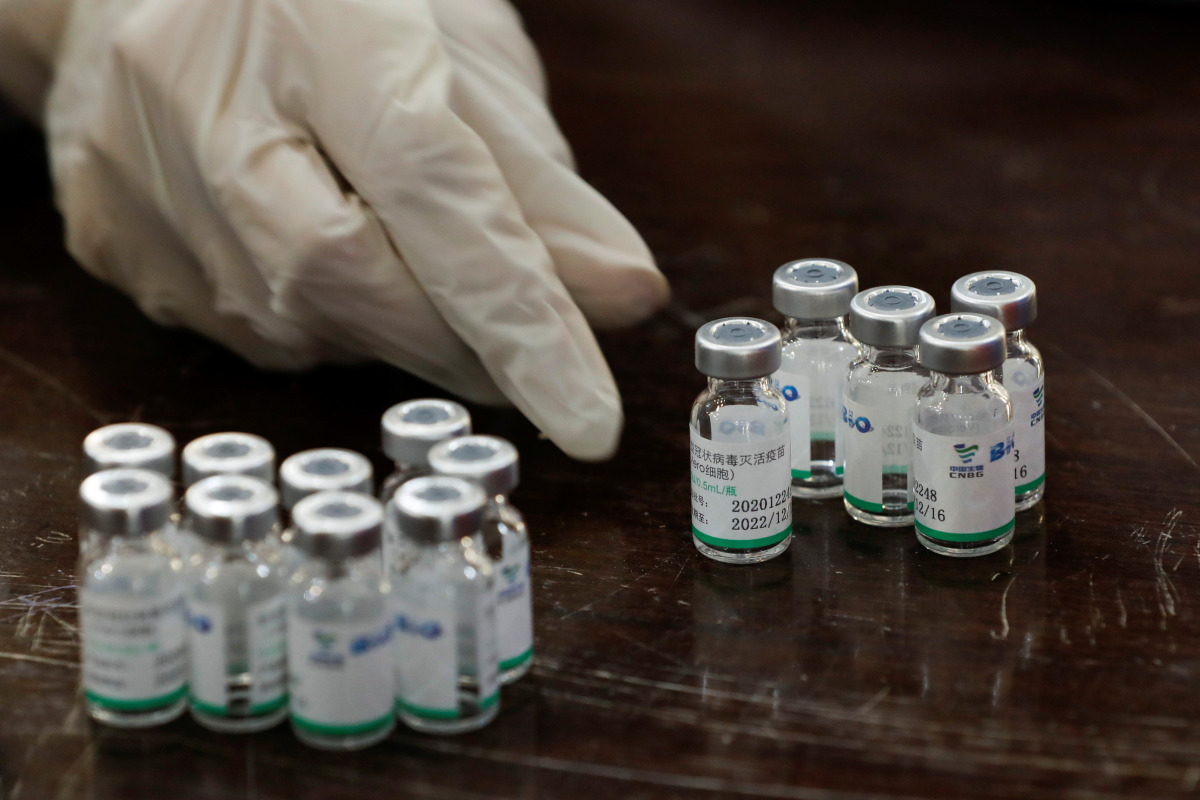 A health worker counts used vials of Sinopharm's coronavirus disease (COVID-19) vaccine, at a vaccination centre in Karachi, Pakistan February 11, 2021. REUTERS/Akhtar Soomro
