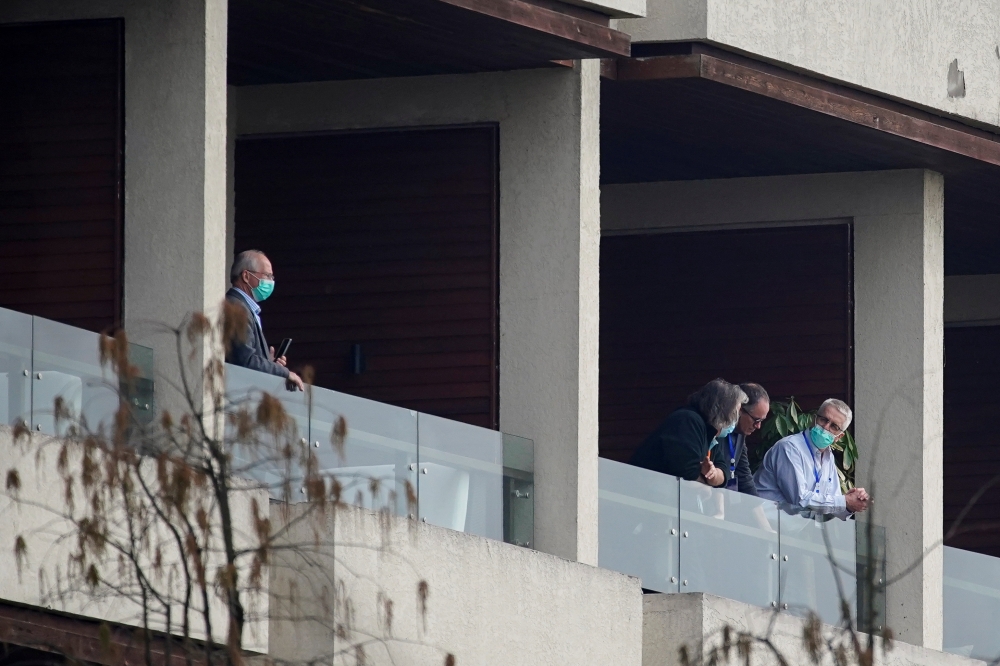Dominic Dwyer, a member of the World Health Organisation (WHO) team tasked with investigating the origins of the coronavirus disease (COVID-19), stands on the balcony of a hotel in Wuhan, Hubei province, China February 8, 2021. REUTERS/Aly Song