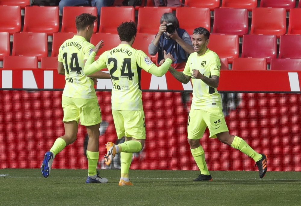 Atletico Madrid's Angel Correa celebrates scoring their second goal with Marcos Llorente and Sime Vrsaljko REUTERS/Jon Nazca