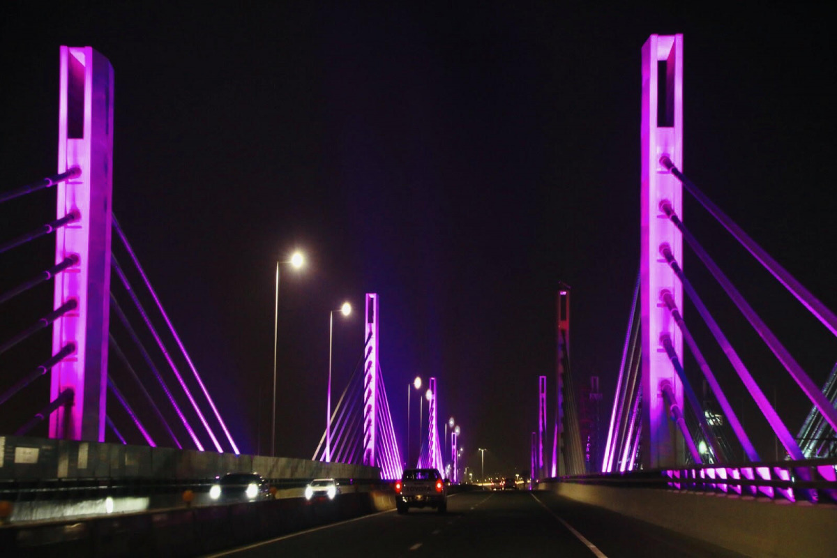 The cable-stayed bridge lit in purple to raise awareness about cancer.