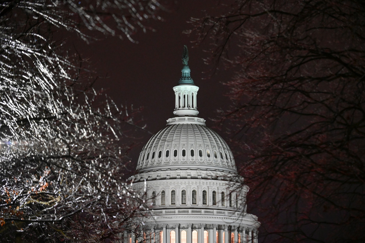 The U.S. Capitol is seen through ice-covered tree branches after the Senate voted to acquit former U.S. President Donald Trump during his impeachment trial, in Washington, U.S. February 13, 2021. REUTERS/Erin Scott

