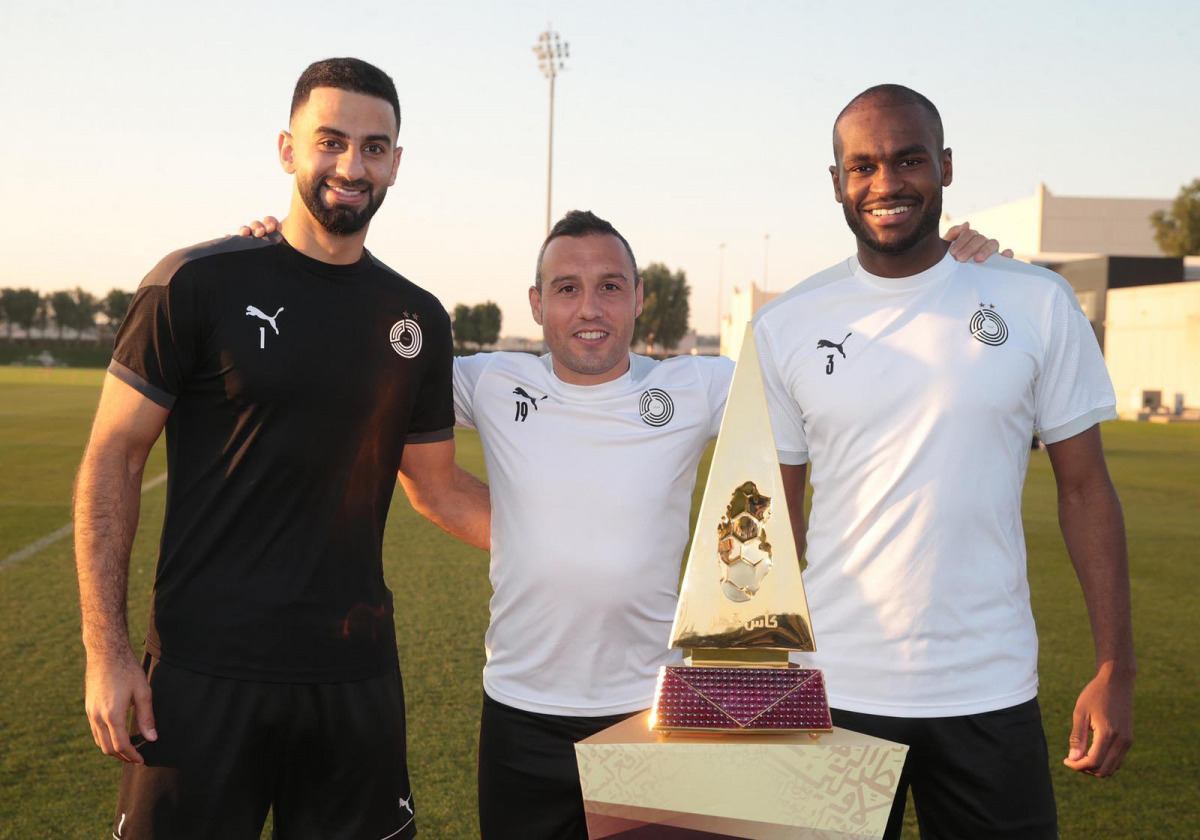 Al Sadd's goalkeeper Saad Al Sheeb, Spanish midfielder Santi Cazorla and Qatari defender Abdelkarim Hassan posing for a photo with the Qatar Cup winner's trophy. Al Sadd are the Qatar Cup title holders.
