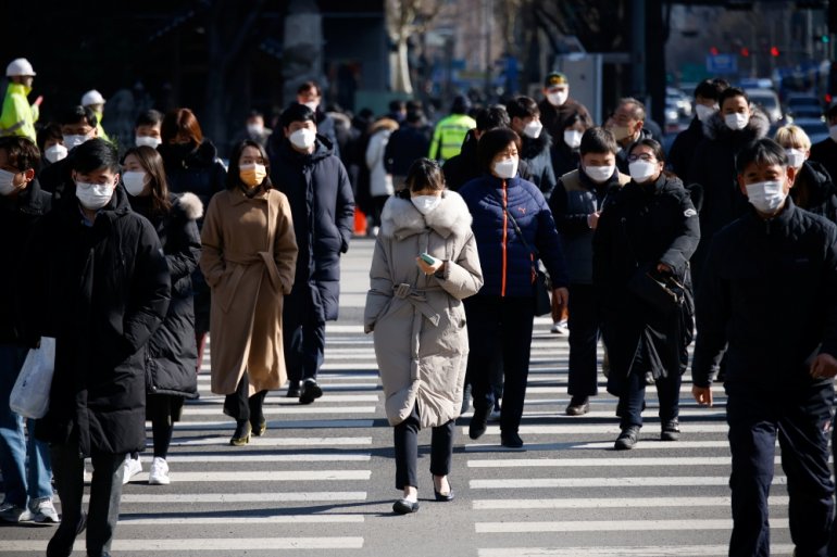 Commuters cross a zebra crossing, amid the coronavirus disease (COVID-19) pandemic in Seoul, South Korea, February 3, 2021. REUTERS/Kim Hong-Ji