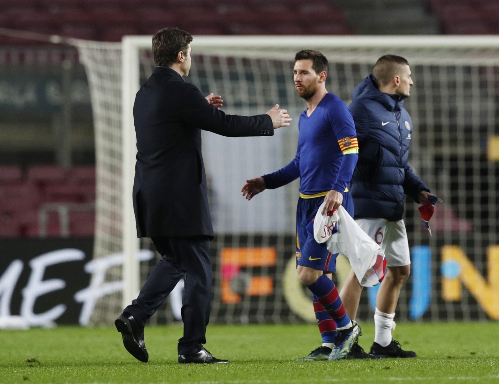 Barcelona's Lionel Messi with Paris St Germain coach Mauricio Pochettino after the match REUTERS/Albert Gea