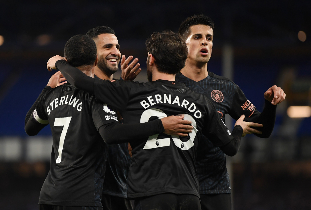 Soccer Football - Premier League - Everton v Manchester City - Goodison Park, Liverpool, Britain - February 17, 2021 Manchester City's Bernardo Silva celebrates scoring their third goal with Riyad Mahrez and teammates Pool via REUTERS/Michael Regan 