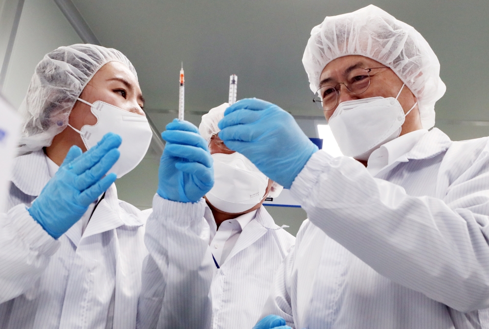 South Korean President Moon Jae-in inspects a LDS (low dead space) syringes plant in Gunsan, South Korea, February 18, 2021. Yonhap via REUTERS