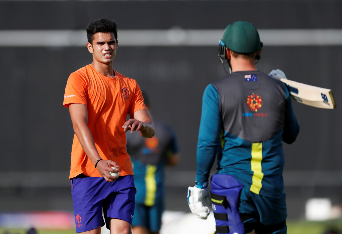 FILE PHOTO: Cricket - ICC Cricket World Cup - Australia Training - Lord's Cricket Ground, London, Britain - June 28, 2019 Arjun Tendulkar, son of Sachin Tendulkar, speaks with Australia's Aaron Finch during training Action Images via Reuters/Paul Childs/F