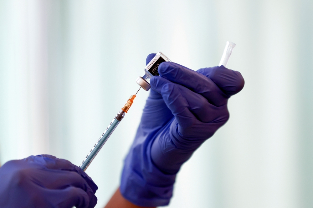 A medical worker fills a syringe with a dose of the Pfizer-BioNTech coronavirus disease (COVID-19) vaccine as Japan launches its inoculation campaign, at Tokyo Medical Center in Tokyo, Japan February 17, 2021. Behrouz Mehri/Pool via REUTERS/File Photo