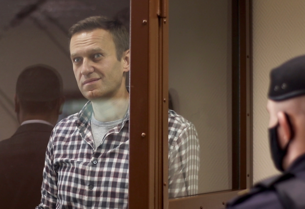 Russian opposition leader Alexei Navalny attends a hearing to consider an appeal against an earlier court decision to change his suspended sentence to a real prison term, in Moscow, Russia February 20, 2021, in this still image taken from video. 