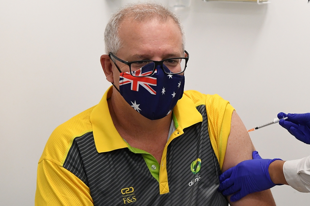 Australian Prime Minister Scott Morrison receives his COVID-19 vaccination during a visit to Castle Hill Medical Centre to preview the COVID-19 vaccination program on Sunday, in Sydney, Australia February 21, 2021. AAP Image/Joel Carrett/via Reuters