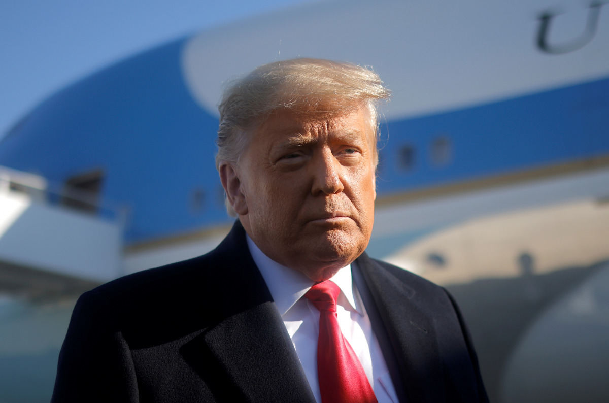 FILE PHOTO: U.S. President Donald Trump looks on as he speaks to the media before boarding Air Force One to depart Washington on travel to visit the U.S.-Mexico border Wall in Texas, at Joint Base Andrews in Maryland, U.S., January 12, 2021. REUTERS/Carlo