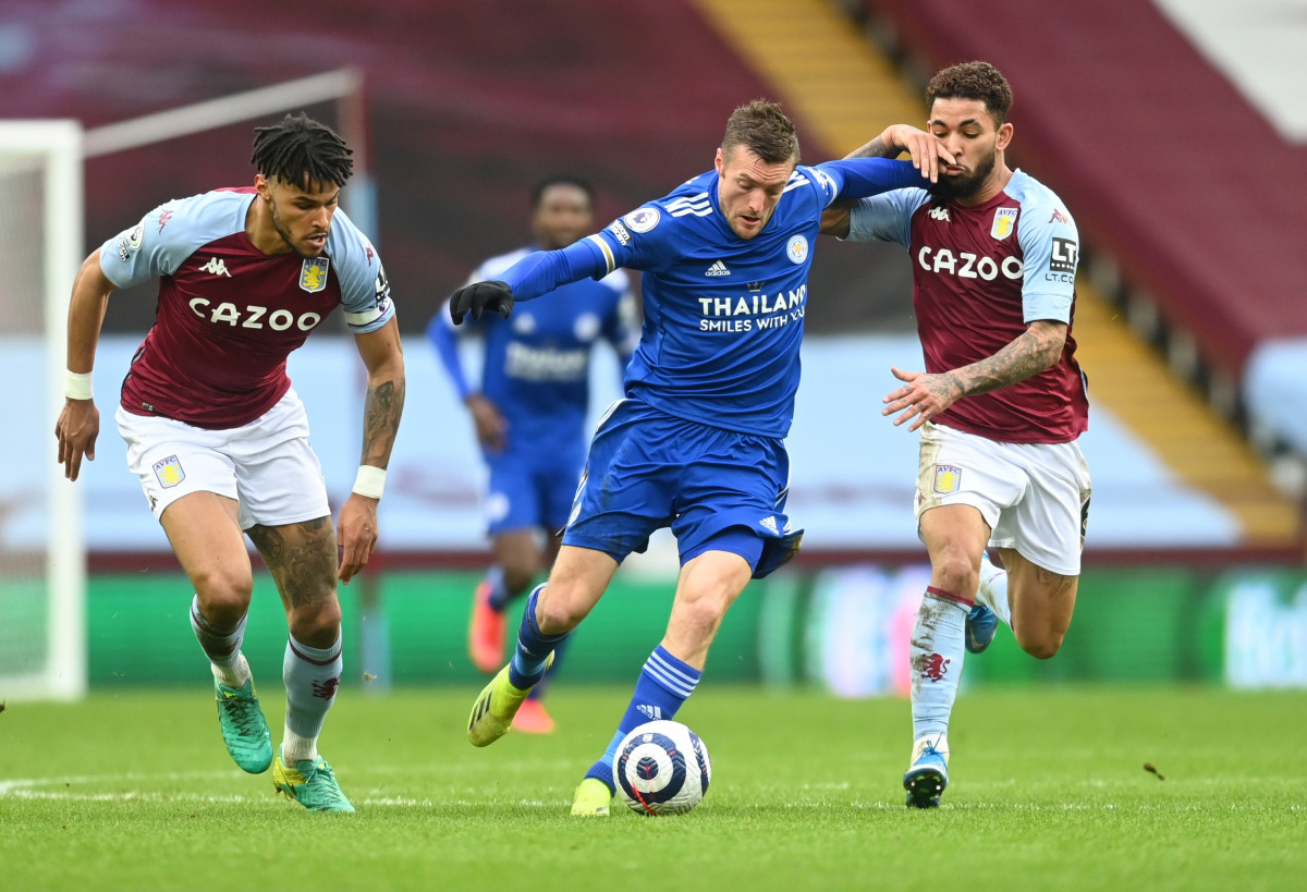 Soccer Football - Premier League - Aston Villa v Leicester City - Villa Park, Birmingham, Britain - February 21, 2021 Leicester City's Jamie Vardy in action with Aston Villa's Douglas Luiz and Tyrone Mings Pool via REUTERS/Michael Regan