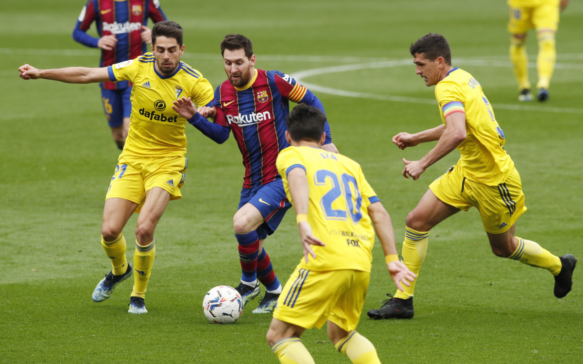 Soccer Football - La Liga Santander - FC Barcelona v Cadiz - Camp Nou, Barcelona, Spain - February 21, 2021 Barcelona's Lionel Messi in action with Cadiz's Ruben Sobrino REUTERS/Albert Gea
