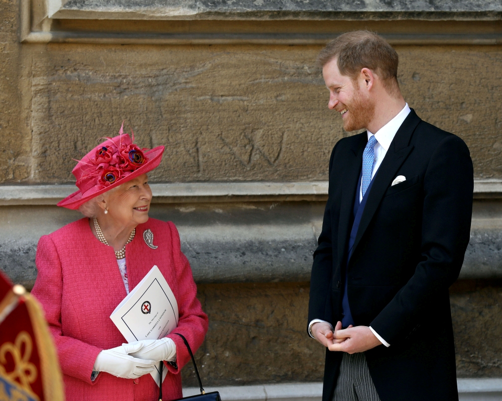 Queen Elizabeth II talks to Prince Harry as they leave after the wedding of Lady Gabriella Windsor and Thomas Kingston at St George's Chapel in Windsor Castle, near London, Britain May 18, 2019. Steve Parsons/Pool via Reuters