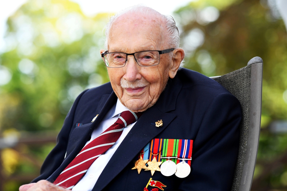 Captain Sir Tom Moore smiles as he launches his autobiography book 'Tomorrow will be a Good Day' at his home in Milton Keynes, Britain September 17, 2020. REUTERS/Dylan Martinez/File Photo