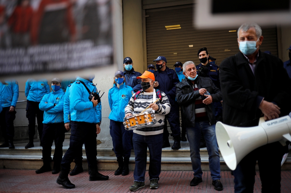 Demonstrators stand next to police officers as Greek hospital doctors and staff take part in a demonstration against a lack of intensive care units at public hospitals, amidst the spread of the coronavirus disease (COVID-19) in Athens, Greece, February 23