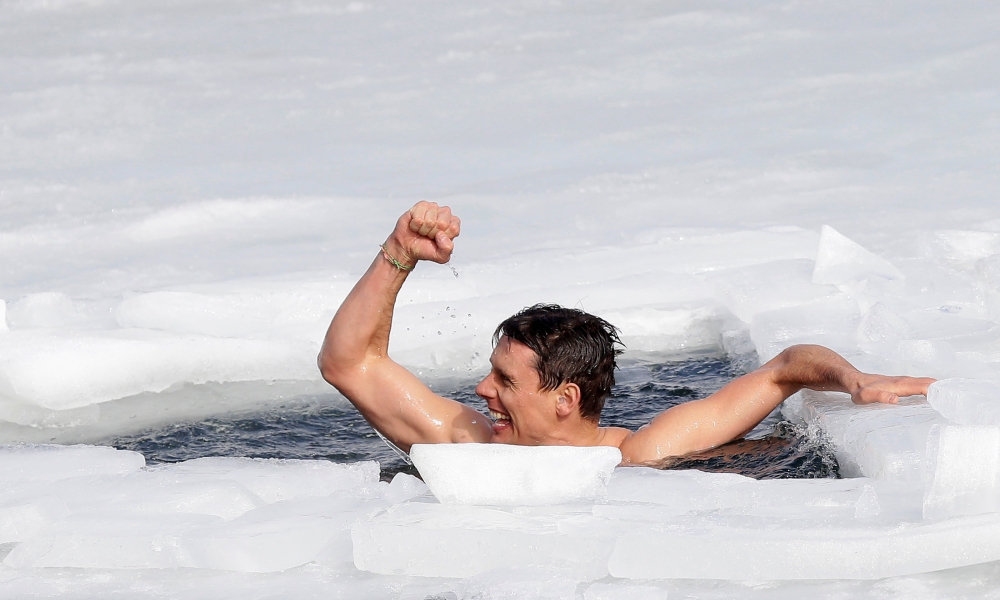 Czech free-diver David Vencl reacts after breaking the new world record in under-ice swimming in a lake at a former quarry in the village of Lahost near the city of Teplice, Czech Republic, February 23, 2021.  REUTERS/David W Cerny