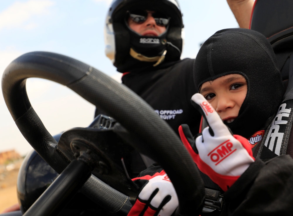 Egyptian Mansour Tarek, 5, son of international rally racer Tarek el-Erian, reacts after completing in a one-day racing event in Giza, Egypt February 20, 2021. Picture taken February 20, 2021. REUTERS/Amr Abdallah Dalsh