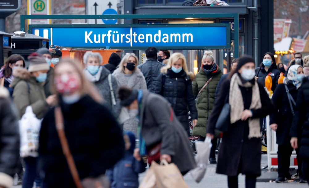 FILE PHOTO: People with protective face masks walk at Kurfurstendamm shopping boulevard, amid the coronavirus disease (COVID-19) outbreak in Berlin, Germany, December 5, 2020. REUTERS/Fabrizio Bensch/File Photo