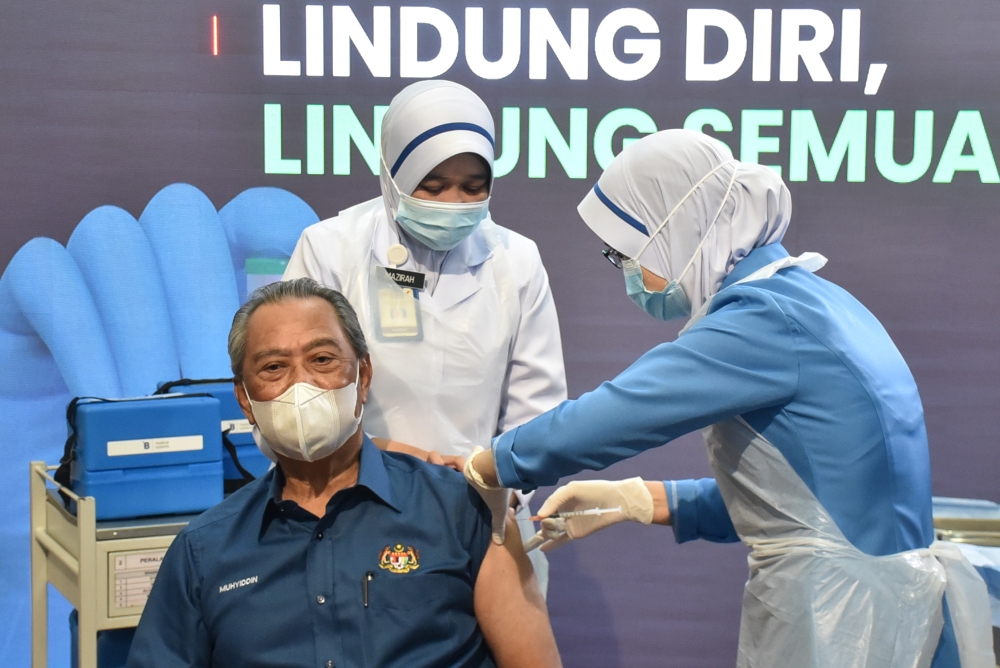 Malaysia's Prime Minister Muhyiddin Yassin receives the first dose of Pfizer-BioNTech COVID-19 vaccine at a clinic in Putrajaya, Malaysia February 24, 2021. Malaysia's Information Department/Muzzafar Kasim/Handout via REUTERS