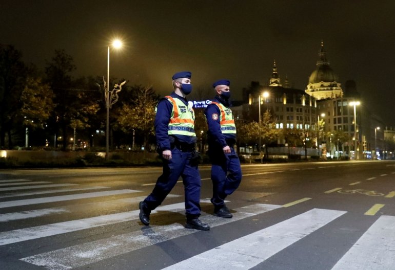 Police officers patrol during a night-time curfew imposed by the Hungarian government to curb the spread of the coronavirus, in Budapest, Hungary, November 11, 2020. REUTERS/Bernadett Szabo/File Photo/File Photo