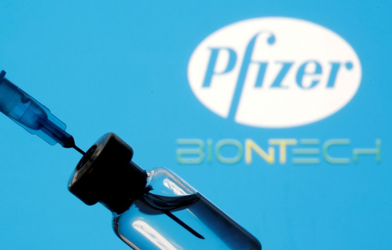 FILE PHOTO: A vial and sryinge are seen in front of a displayed Pfizer and Biontech logo in this illustration taken January 11, 2021. REUTERS/Dado Ruvic/Illustration/File Photo