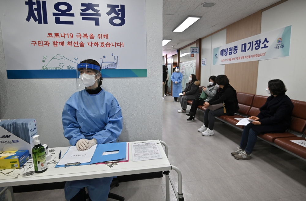 Nursing home workers (R) wait to receive the first dose of the AstraZeneca Covid-19 vaccine at a health care centre in Seoul on February 26, 2021, as South Korea starts coronavirus vaccination campaign. Jung Yeon-je/Pool via REUTERS
