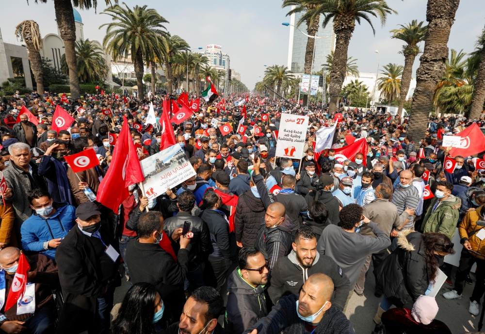 Supporters of Tunisia's biggest political party, the moderate Islamist Ennahda, march during a rally in opposition to President Kais Saied, in Tunis, Tunisia February 27, 2021. REUTERS/Zoubeir Souissi