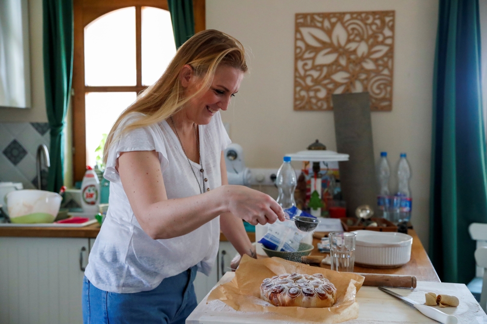 Eszter Harmath prepares a cake at home during the coronavirus disease (COVID-19) pandemic, in Szentendre, Hungary, February 26, 2021. Picture taken February 26, 2021. Reuters/Bernadett Szabo