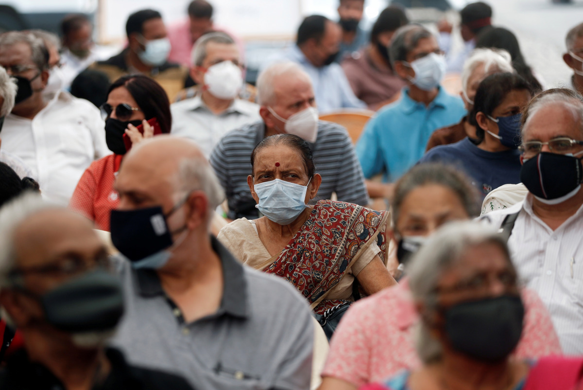 FILE PHOTO: People wait to receive a dose of COVISHIELD, a COVID-19 vaccine manufactured by Serum Institute of India, in Mumbai, India, March 1, 2021. REUTERS/Francis Mascarenhas/File Photo

