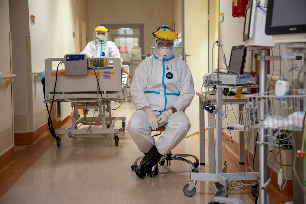 Doctor Lukasz Grabarczyk sits inside the coronavirus disease (COVID-19) ward at the University Clinical Hospital in Olsztyn, Poland, March 2, 2021. Picture taken March 2, 2021. REUTERS/Kuba Stezycki