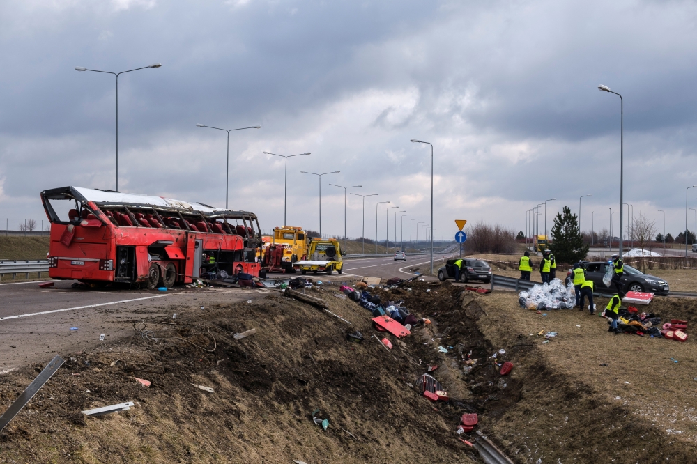 Emergency workers inspect the site of a Ukrainian bus crash on the side of A4 highway from Jaroslaw to Korczowa, near Koszyce, Poland March 6, 2021. Agencja Gazeta/Patryk Ogorzalek via REUTERS 