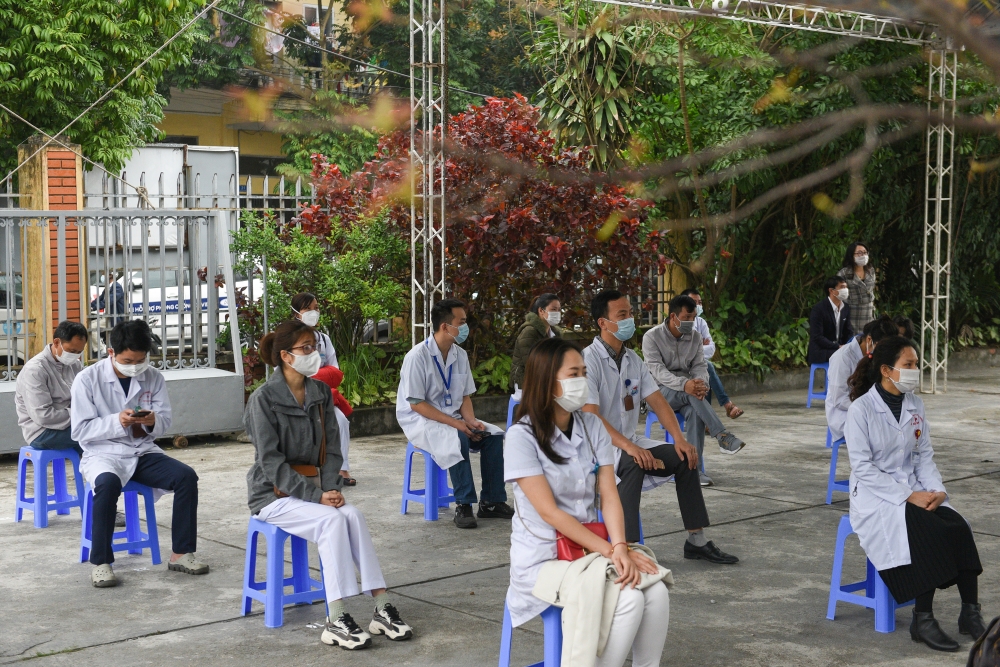 Health workers wait for their turn as Vietnam starts its official rollout of AstraZeneca's coronavirus disease (COVID-19) vaccine for health workers, at Hai Duong Hospital for Tropical Diseases, Hai Duong province, Vietnam, March 8, 2021. REUTERS/Thanh Hu