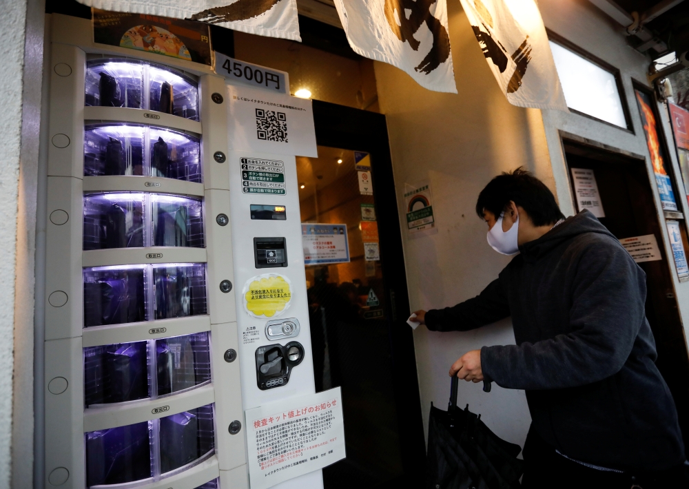 A vending machine selling a polymerase chain reaction (PCR) test for the coronavirus disease (COVID-19), operated by Takenoko ENT Clinic, is installed at the entrance of a ramen noodle shop at Shibuya district in Tokyo, Japan March 8, 2021. REUTERS/Issei 