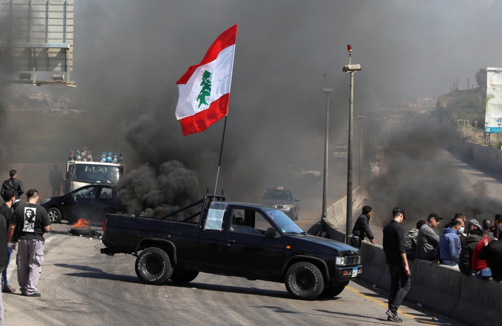 A vehicle blocks a road during a protest against the fall in Lebanese pound currency and mounting economic hardships in Khaldeh, Lebanon March 8, 2021. REUTERS/Mohamed Azakir