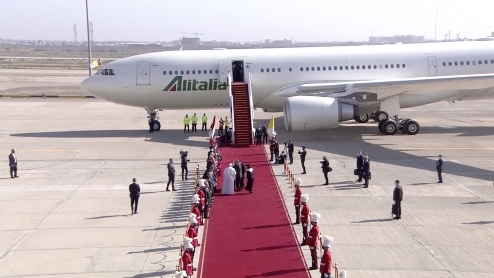 Pope Francis is accompanied by Iraqi President Barham Salih and his wife Sarbagh Salih during the Pope's farewell ceremony before departing for Rome, at Baghdad International Airport in Baghdad, Iraq, March 8, 2021