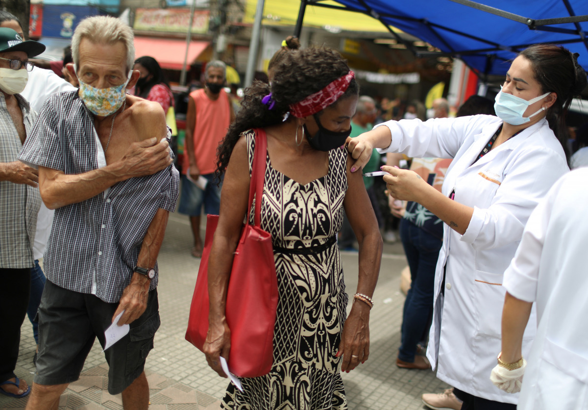 People receive the first dose of Sinovac's CoronaVac coronavirus disease (COVID-19) vaccine for senior citizens, in Duque de Caxias, Rio de Janeiro state, Brazil March 5, 2021. REUTERS/Pilar Olivares
