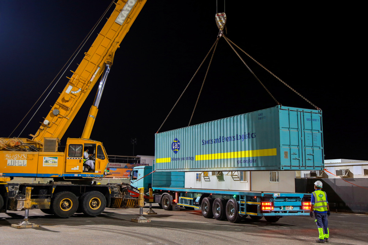 GAC Qatar staff unloading containers at Losail Circuit Sports Club.