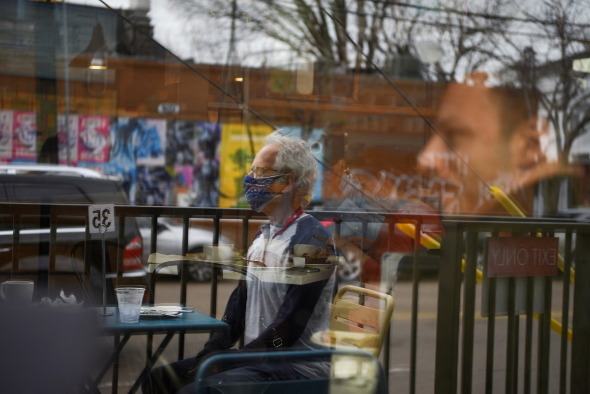 Herb Pasternak wears a mask while dining outdoors as the state of Texas lifts its mask mandate and allows businesses to reopen at full capacity during the coronavirus disease (COVID-19) pandemic in Houston, Texas, U.S., March 10, 2021. REUTERS/Callaghan O