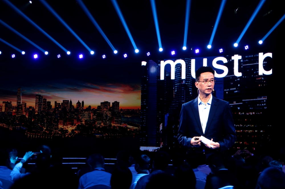 Simon Hu, CEO of Ant Group, is seen on a giant screen as he delivers a speech at the INCLUSION Fintech Conference in Shanghai, China September 24, 2020. REUTERS/Cheng Leng/File Photo