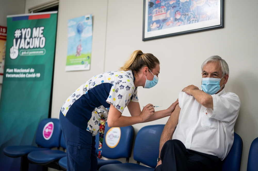 Chilean President Sebastian Pinera receives his second dose of Sinovac's CoronaVac coronavirus disease (COVID-19) vaccine at a health care centre in Santiago, Chile, March12, 2021. Sebastian Rodriguez/Courtesy of Chilean Presidency/Handout via REUTERS