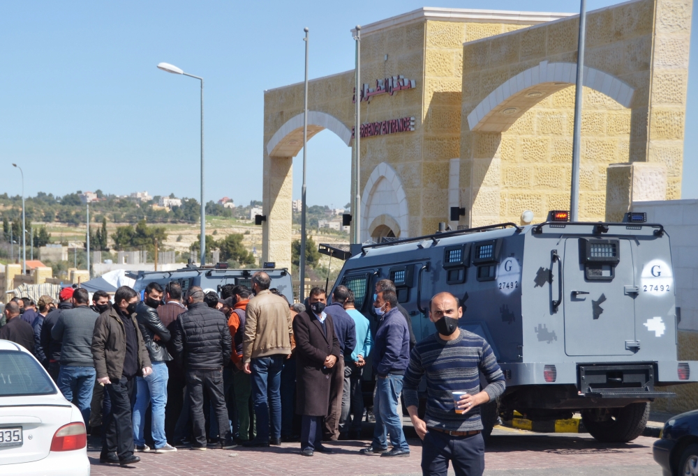 People gather outside the new Salt government hospital in the city of Salt, Jordan March 13, 2021. REUTERS/Muath Freij 