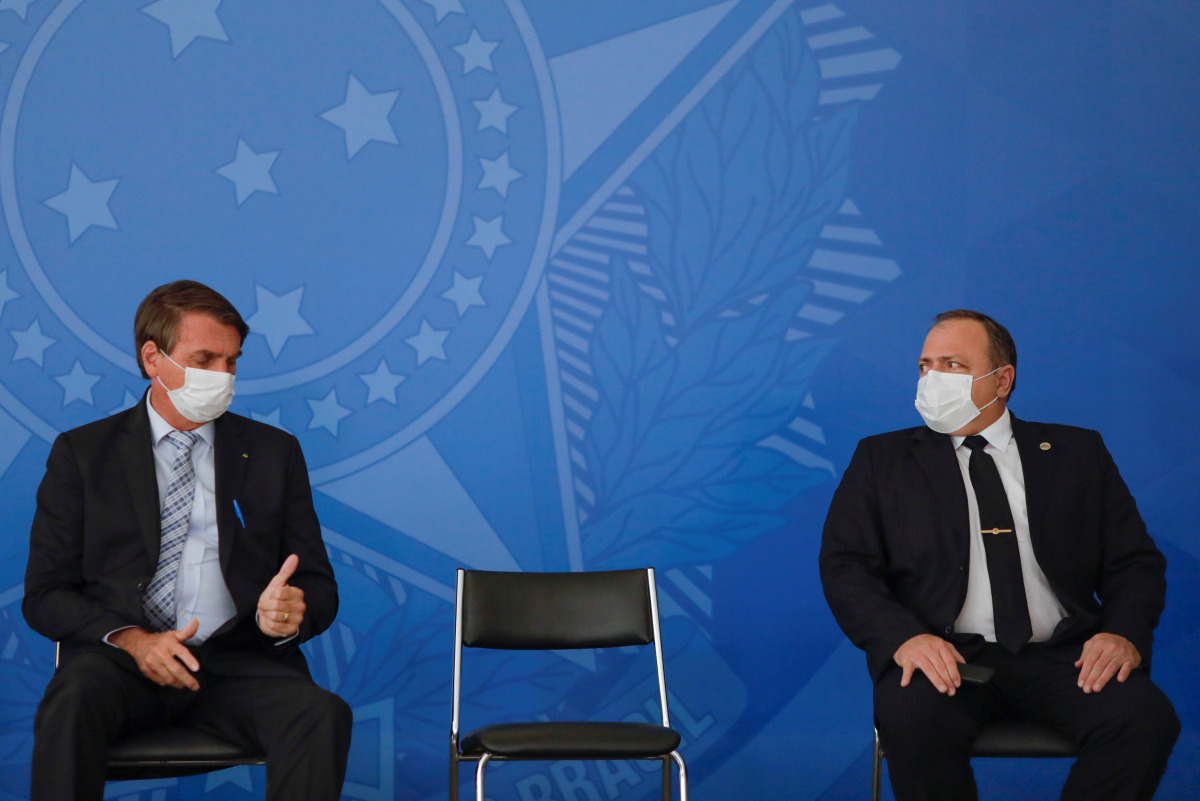Brazil's President Jair Bolsonaro gestures to Brazil's Health Minister Eduardo Pazuello during a ceremony to expand the ability of the government to purchase vaccines against COVID-19, amid the coronavirus disease (COVID-19) outbreak, in Brasilia, Brazil,