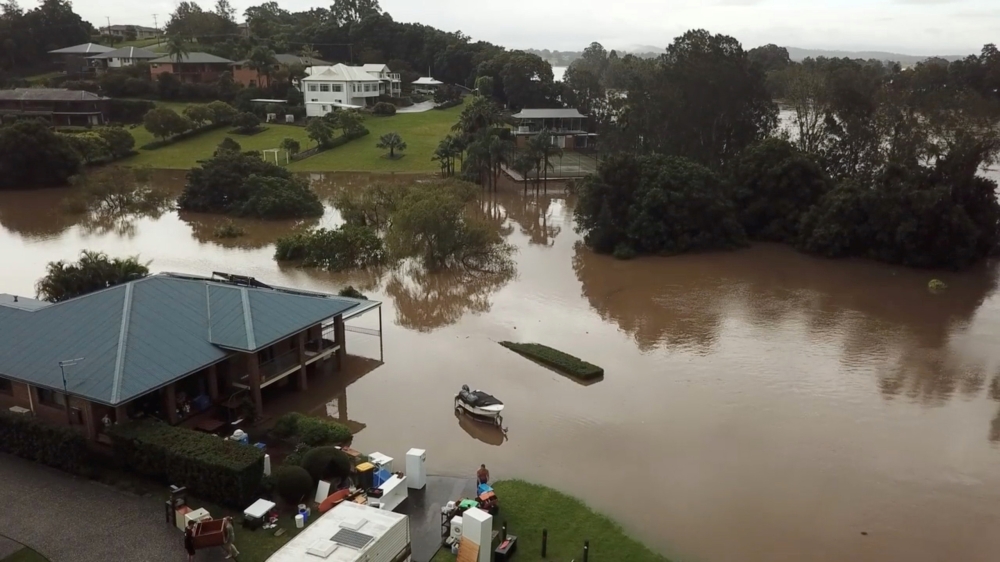 People move their belongings during floods after heavy rainfall in Tinonee, New South Wales, Australia March 20, 2021, in this still image taken from drone video obtained from social media. Simmi Valgeirsson / Reuters