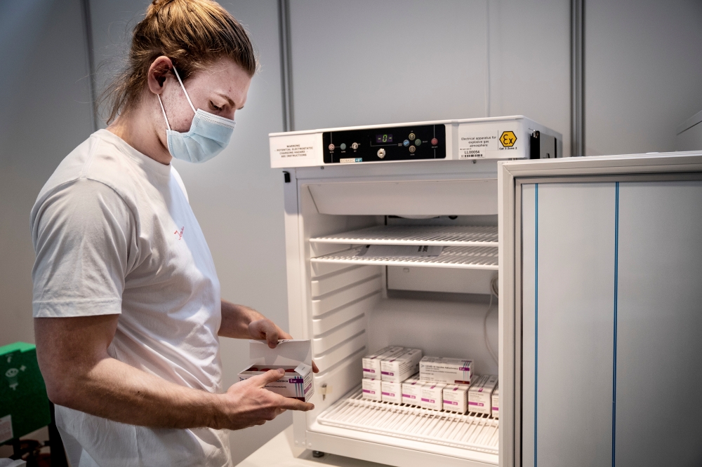 File photo: Staff member handles AstraZeneca COVID-19 vaccines in storage at Region Hovedstaden's Vaccine Center, Copenhagen, Denmark February 11, 2021. Ritzau Scanpix/Liselotte Sabroe via Reuters 